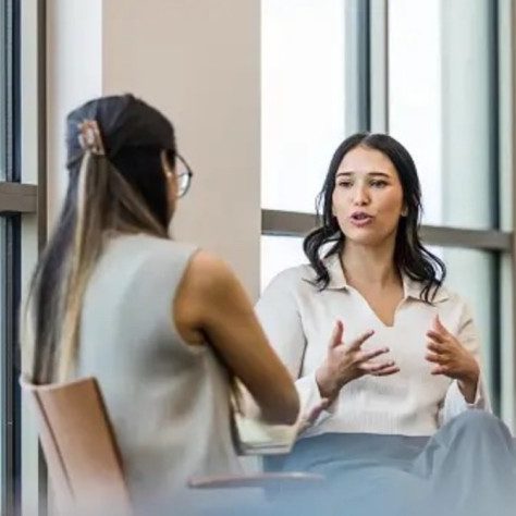 Woman giving individual coaching to another